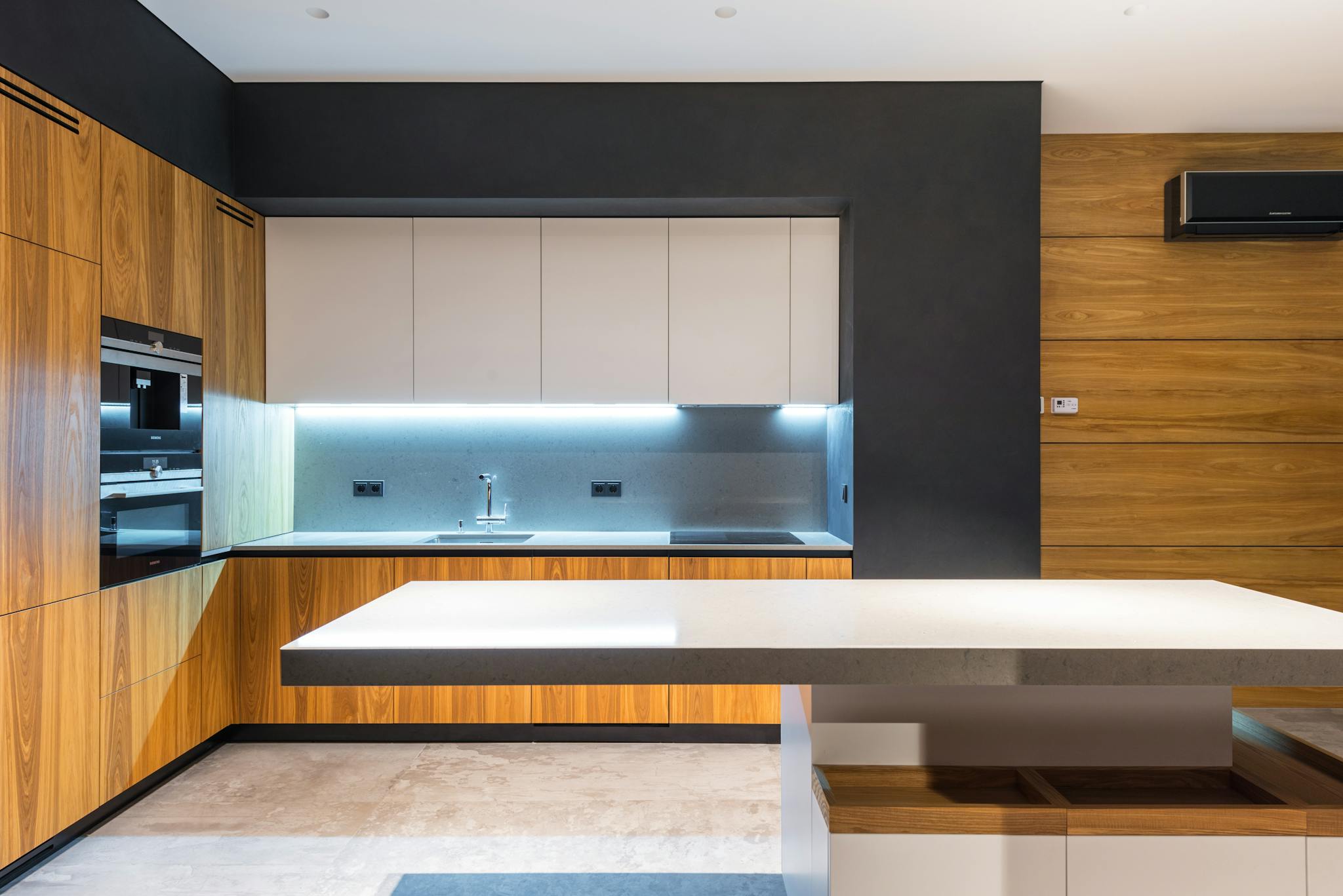 Beautifully refinished modern kitchen with white cabinets and contemporary appliances