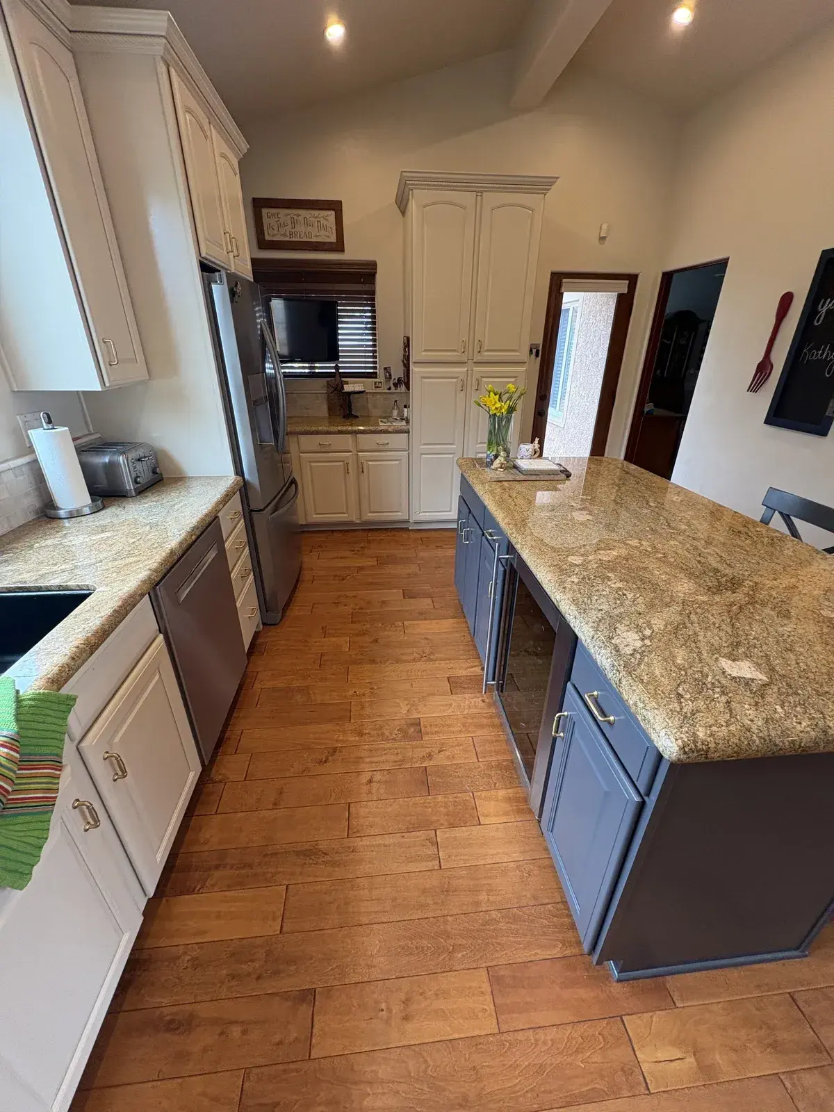 Blue island with white perimeter cabinets — sprayed finish