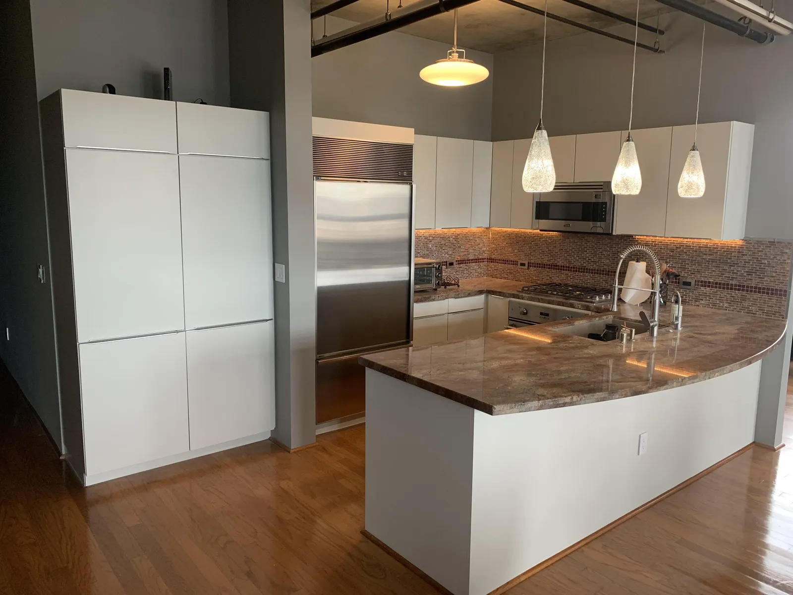 White and blue condo kitchen cabinets