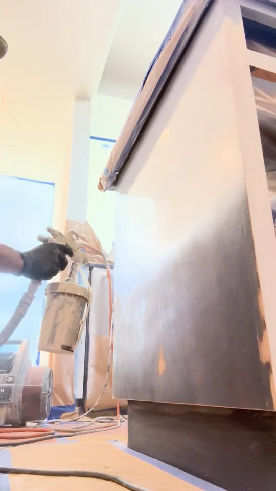 Spraying the first coat of primer on an island panel