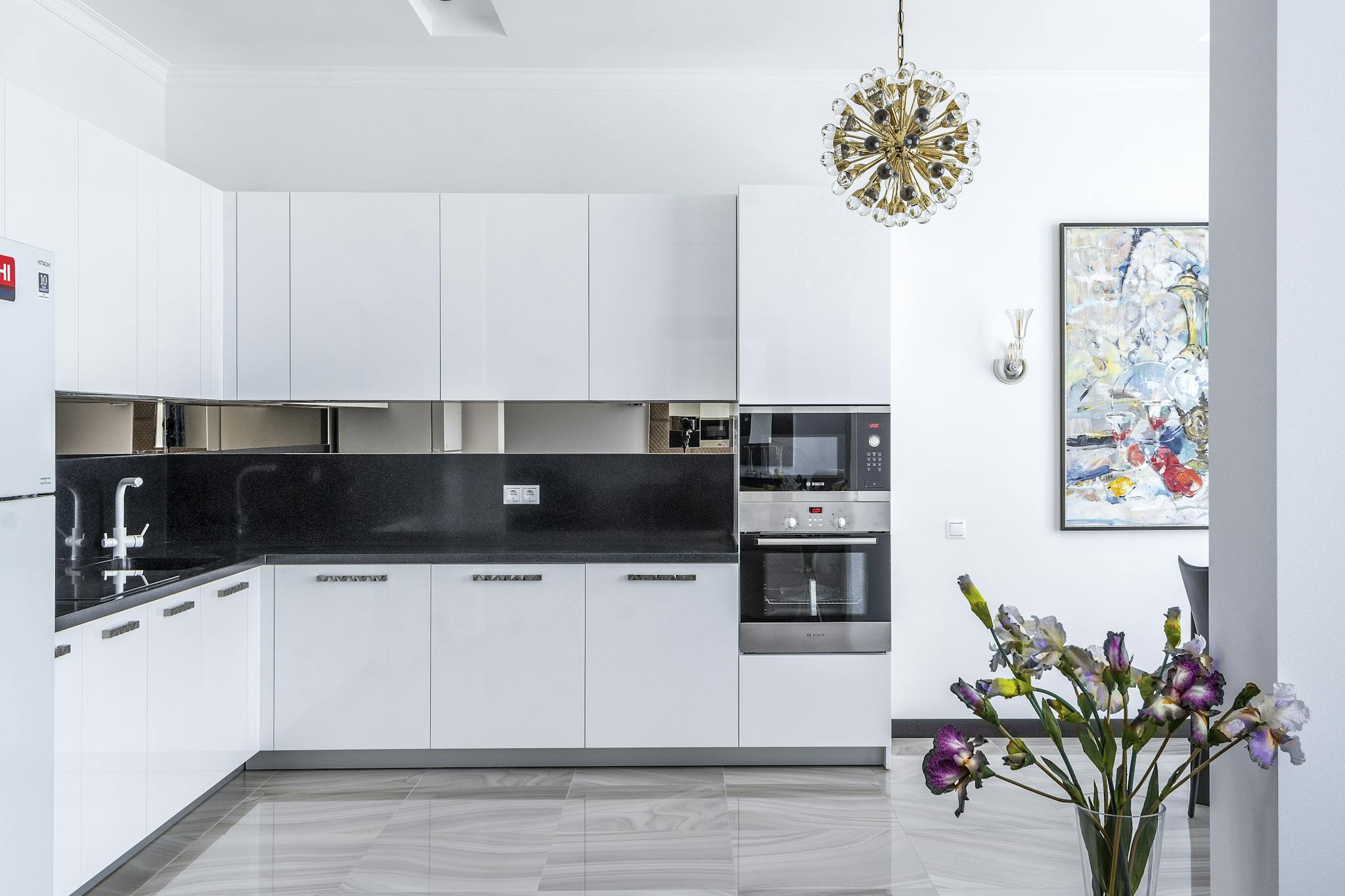 Stylish contemporary kitchen featuring sleek appliances and floral decor.